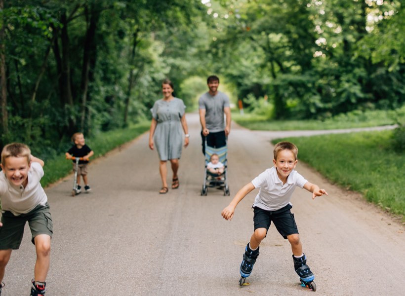 A family walking the trail near the cabins